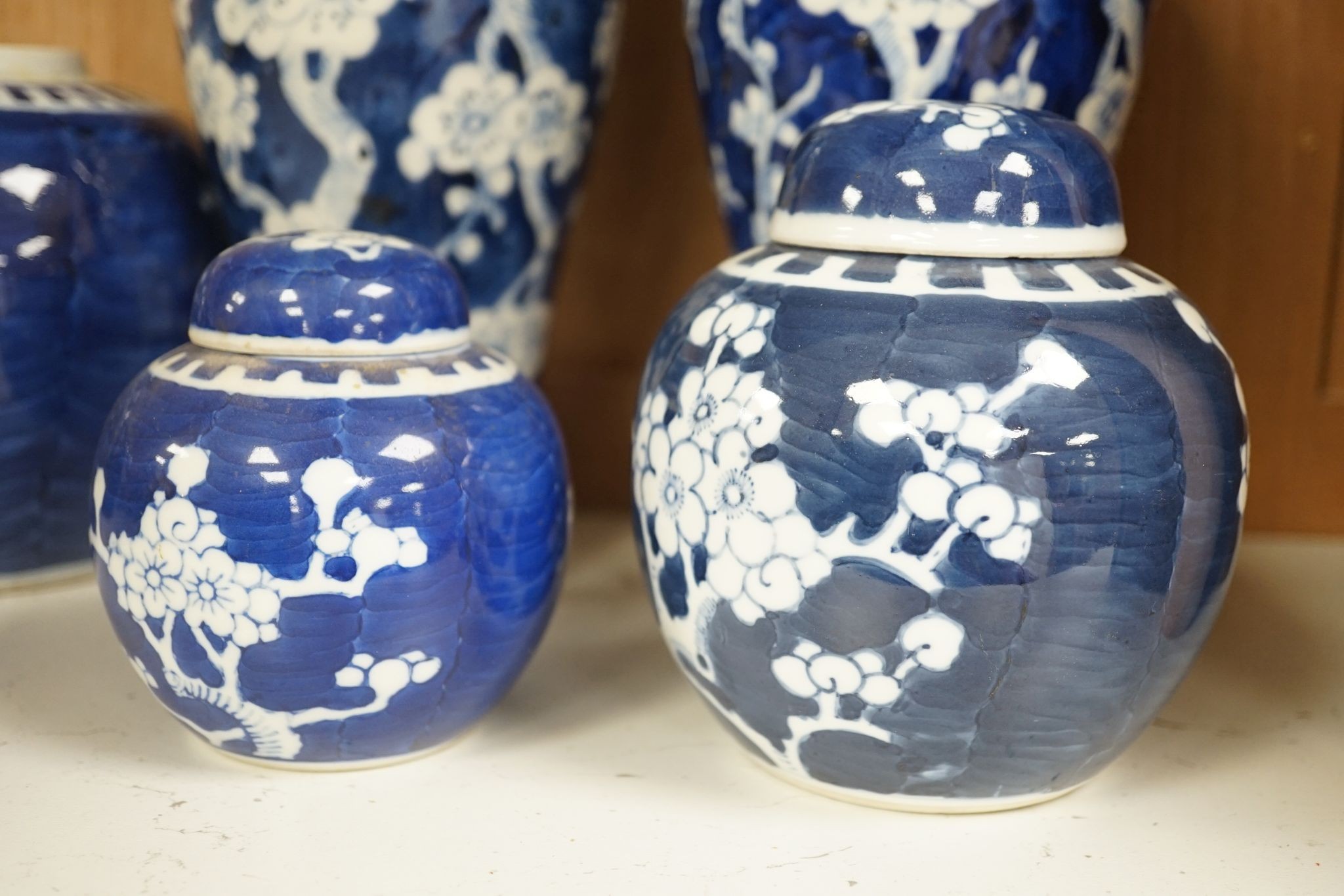 A pair of Chinese blue and white vases and eleven jars, six with covers., Vase and matching cover 28 cms high.